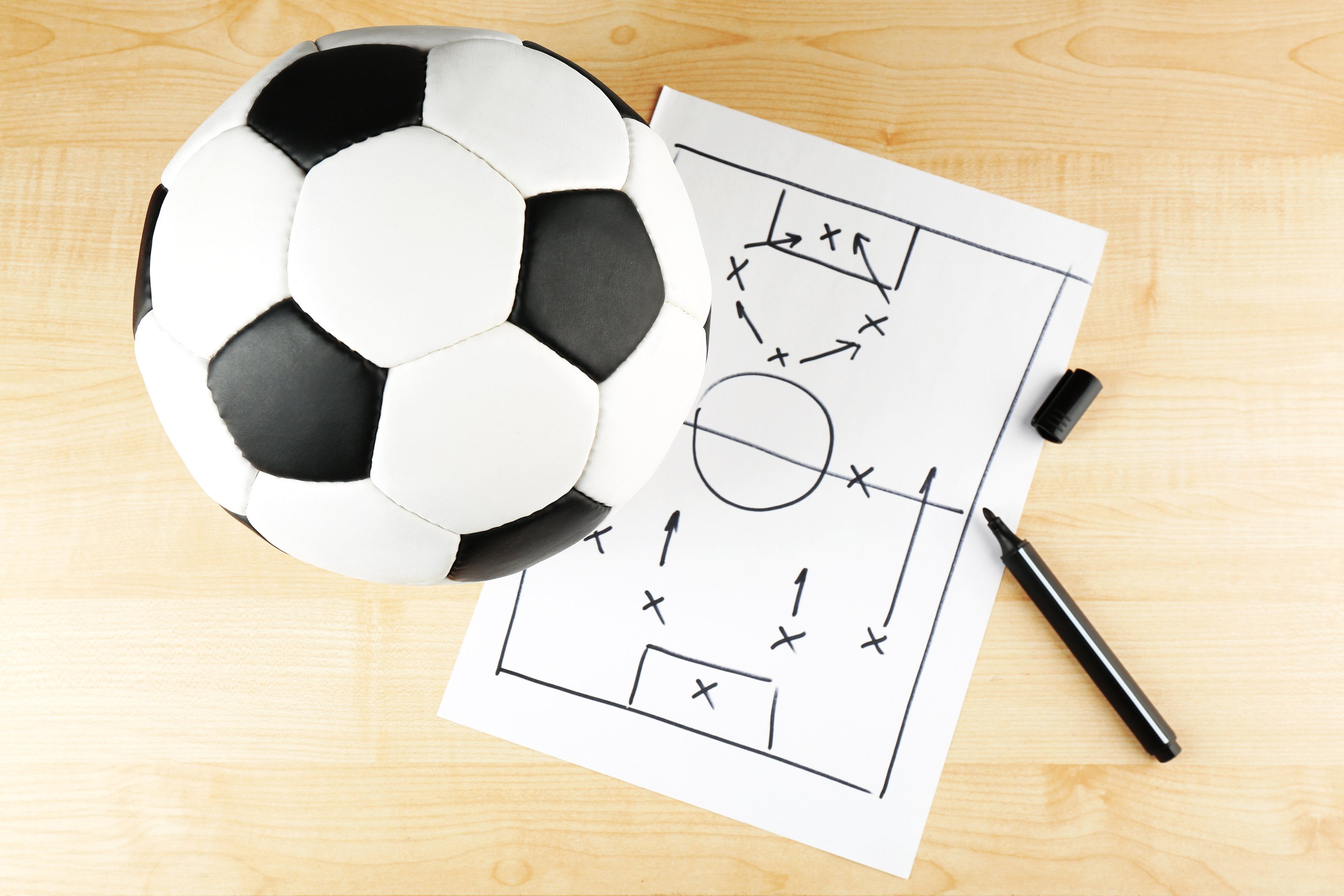 Football Game on Sheet of Paper and Wooden Table