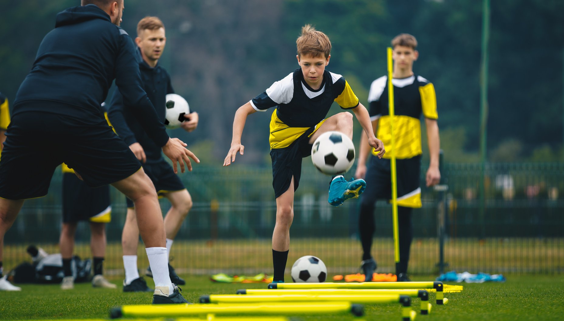 Teenage Boys on Football Training Session with Coaches